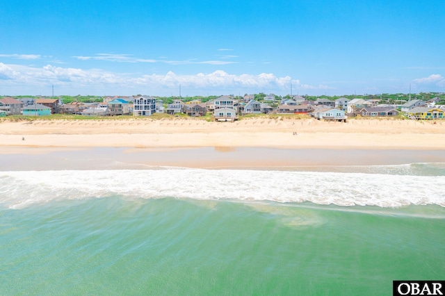 aerial view with a residential view, a water view, and a beach view