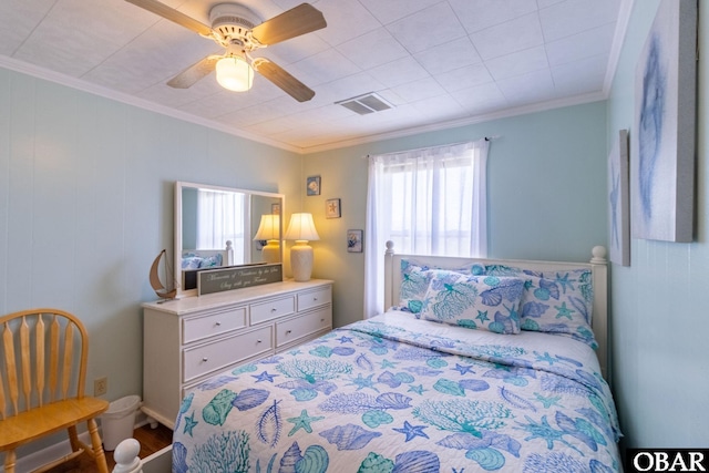 bedroom with a ceiling fan, visible vents, and crown molding