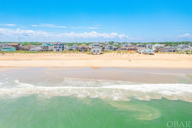 aerial view featuring a water view, a residential view, and a beach view