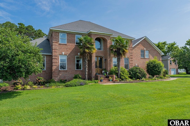 118 Neversail Way Lot 17, Coinjock, NC 27923 - view of front of property featuring a shingled roof, a front lawn, and brick siding