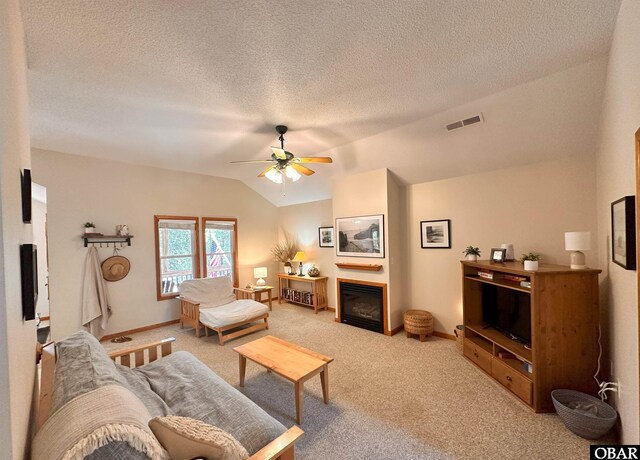 2018 Sea Horse Rd Lot # 67, Corolla, NC 27927 - living room with ceiling fan, light colored carpet, lofted ceiling, a glass covered fireplace, and a textured ceiling