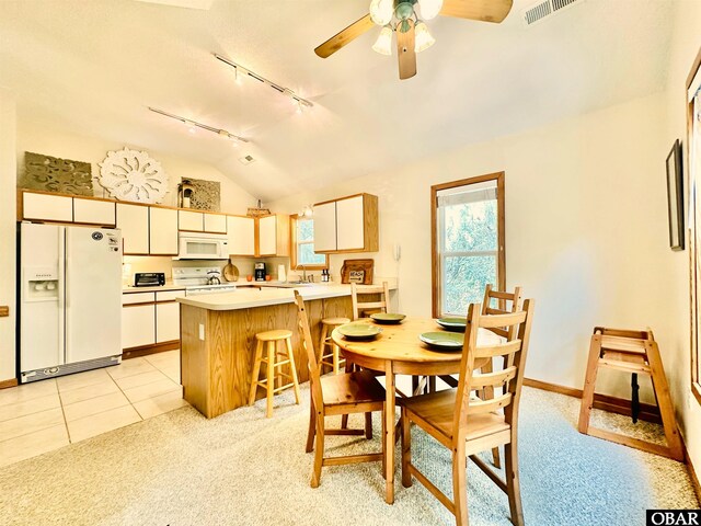 2018 Sea Horse Rd Lot # 67, Corolla, NC 27927 - dining room featuring track lighting, ceiling fan, lofted ceiling, light tile patterned flooring, and light carpet