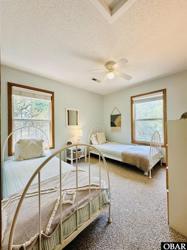 2018 Sea Horse Rd Lot # 67, Corolla, NC 27927 - carpeted bedroom featuring a textured ceiling and ceiling fan