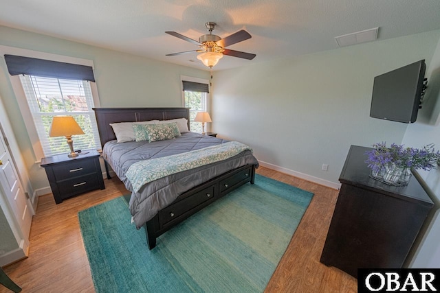 26223A Bluebeard Rd Lot 88, Salvo, NC 27972 - bedroom with light wood-type flooring, baseboards, and a ceiling fan