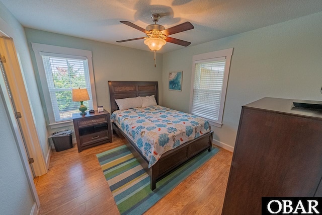 26223A Bluebeard Rd Lot 88, Salvo, NC 27972 - bedroom with light wood-type flooring, baseboards, and a ceiling fan