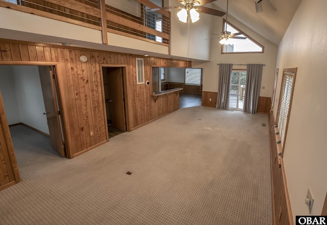 50078 Live Oak Ln Lot # 2, Frisco, NC 27936 - unfurnished living room featuring high vaulted ceiling, wood walls, carpet flooring, a ceiling fan, and wainscoting