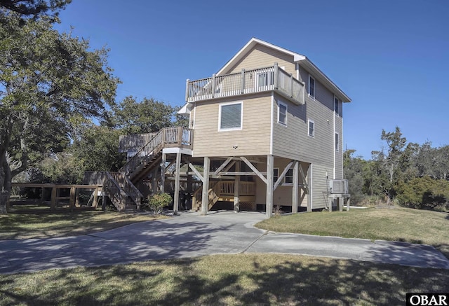 50078 Live Oak Ln Lot # 2, Frisco, NC 27936 - coastal home featuring a carport, concrete driveway, stairway, and a front lawn