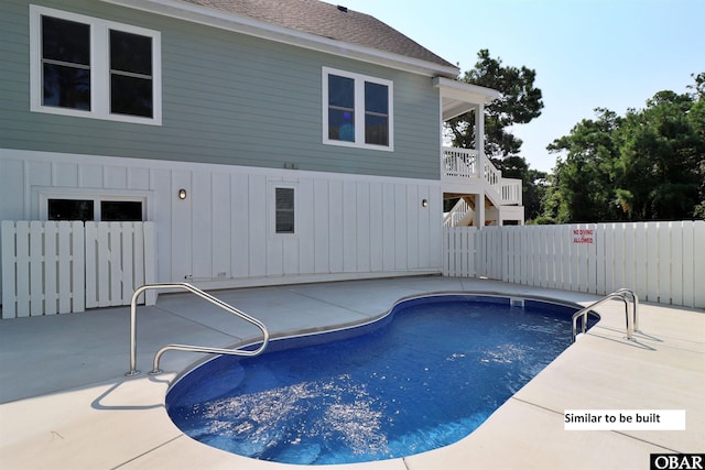 view of swimming pool featuring stairway, a patio, a fenced in pool, and fence
