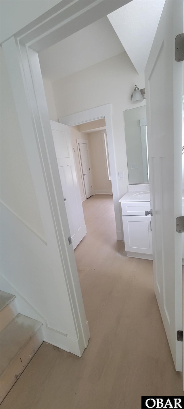 hall featuring stairs and baseboards