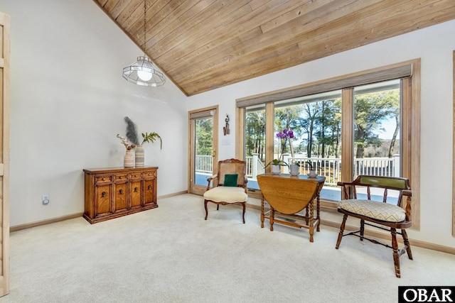 sitting room featuring carpet floors, wood ceiling, and baseboards