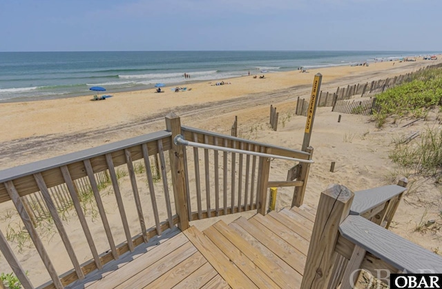 exterior space with a water view and a view of the beach