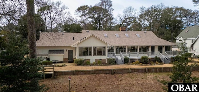 rear view of house featuring crawl space, a sunroom, a shingled roof, and a chimney