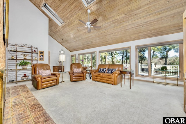 living area with carpet floors, a skylight, wooden ceiling, and high vaulted ceiling