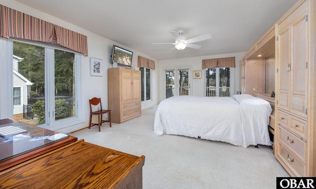 bedroom with a ceiling fan, access to outside, and light colored carpet