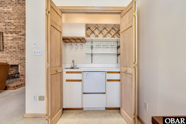 interior space featuring light countertops, light carpet, and a sink