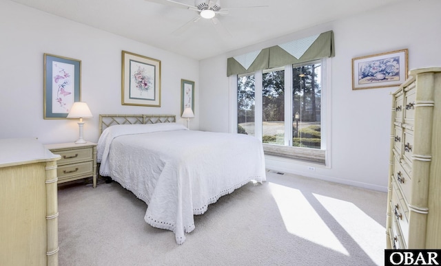 carpeted bedroom with a ceiling fan and baseboards