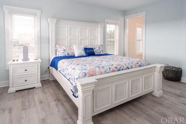 bedroom featuring light wood-type flooring and baseboards