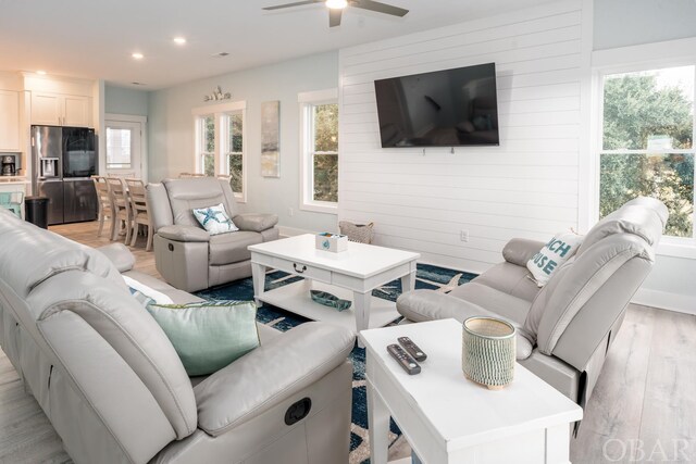 living room with a ceiling fan, a wealth of natural light, light wood-style flooring, and recessed lighting