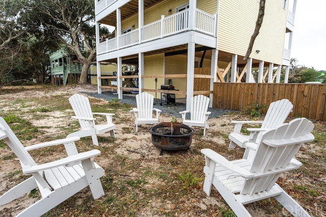 exterior space with an outdoor fire pit and fence