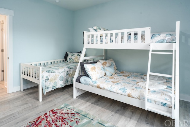 bedroom with wood finished floors and baseboards