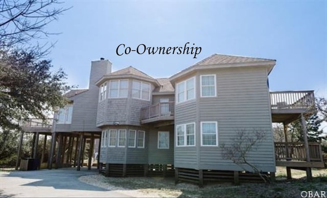 125 Foresail Ct Lot 37, Duck, NC 27949 - back of house featuring a balcony, a chimney, a deck, and a carport