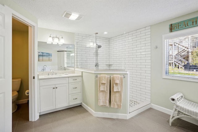 125 Foresail Ct Lot 37, Duck, NC 27949 - full bath featuring walk in shower, toilet, a textured ceiling, vanity, and tile patterned flooring