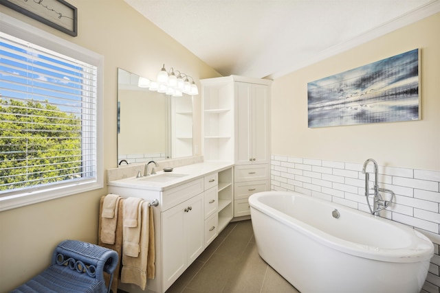 125 Foresail Ct Lot 37, Duck, NC 27949 - bathroom featuring tile patterned flooring, a freestanding tub, vanity, and tile walls