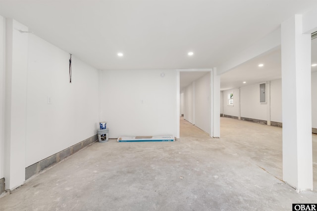 basement featuring electric panel and recessed lighting