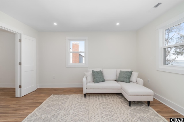 sitting room with visible vents, recessed lighting, wood finished floors, and baseboards