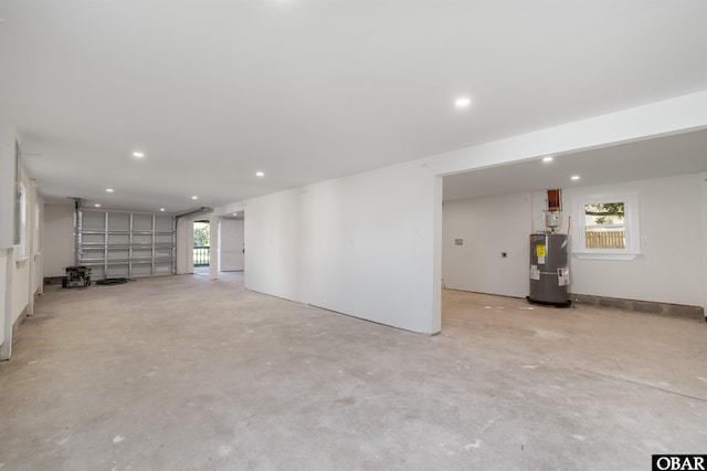 garage featuring recessed lighting and electric water heater