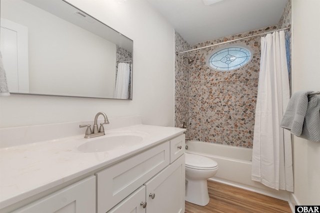 full bath featuring shower / bath combination with curtain, toilet, vanity, and wood finished floors