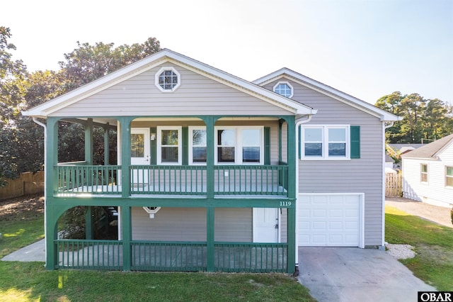 view of front of property with concrete driveway, an attached garage, and fence