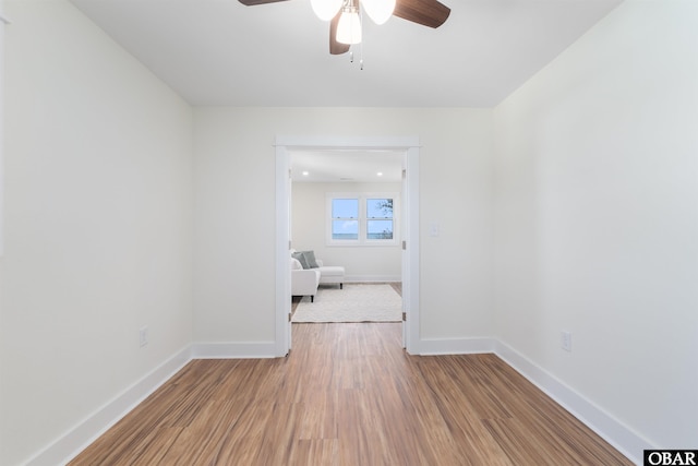 unfurnished bedroom featuring light wood finished floors, ceiling fan, and baseboards