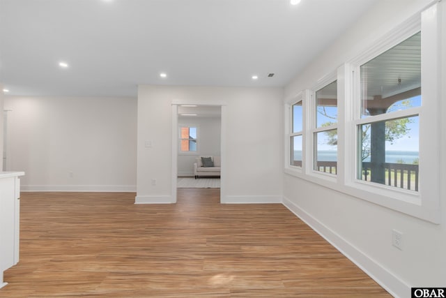 empty room with recessed lighting, baseboards, and light wood-style flooring