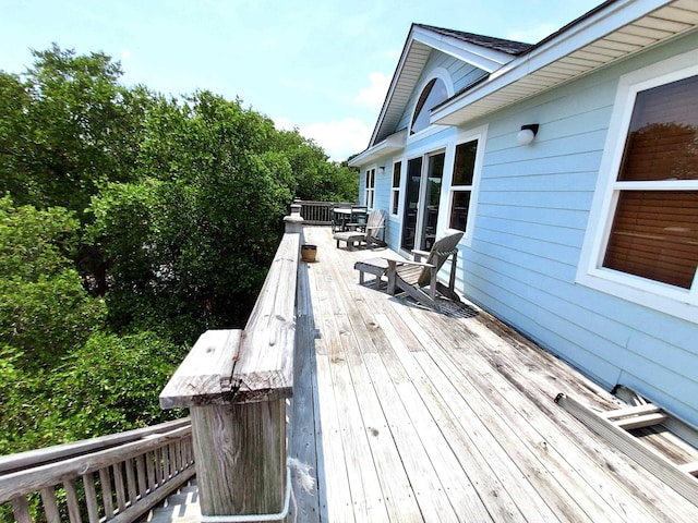 wooden terrace featuring outdoor dining space