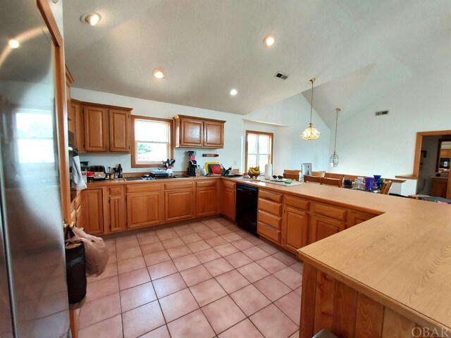 kitchen featuring visible vents, dishwasher, vaulted ceiling, light countertops, and pendant lighting