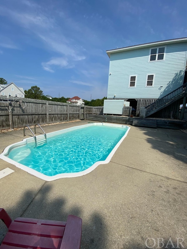 view of swimming pool featuring a patio area, a fenced backyard, and a fenced in pool