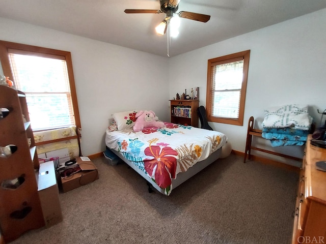 carpeted bedroom with a ceiling fan and baseboards