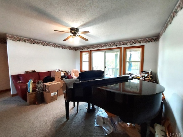 interior space featuring carpet floors, ceiling fan, and a textured ceiling