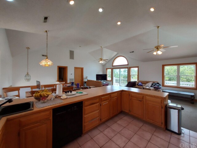 kitchen featuring light countertops, open floor plan, vaulted ceiling, a sink, and dishwasher