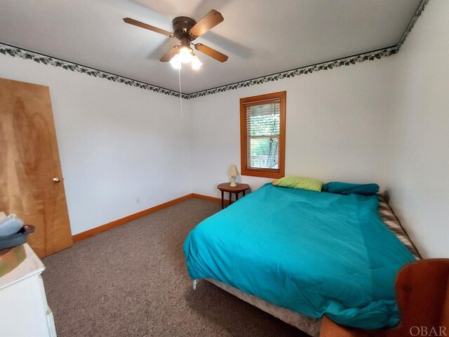 unfurnished bedroom featuring ceiling fan, carpet, and baseboards