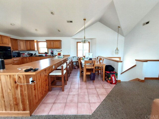 3111 Atlantic View Ct Lot 17, Nags Head, NC 27959 - kitchen with light tile patterned floors, visible vents, lofted ceiling, pendant lighting, and black oven