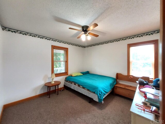 bedroom featuring a ceiling fan, baseboards, a textured ceiling, and carpet flooring