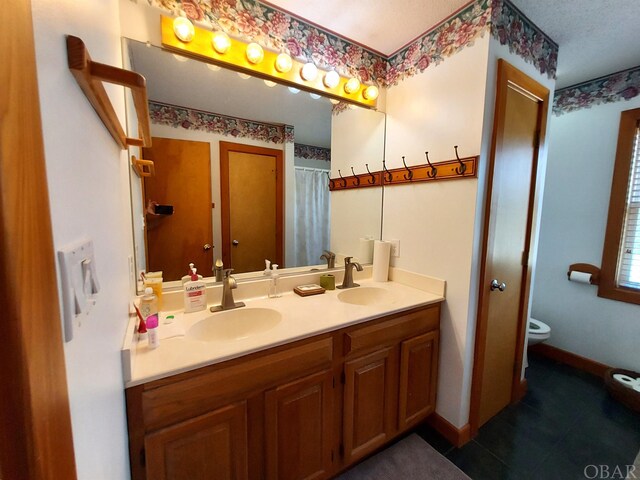 3111 Atlantic View Ct Lot 17, Nags Head, NC 27959 - bathroom featuring double vanity, baseboards, toilet, and a sink