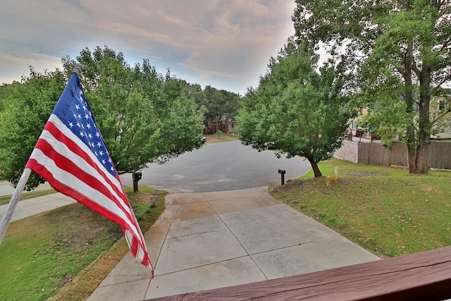 surrounding community featuring a yard and fence