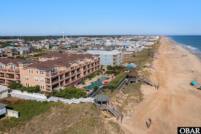 aerial view with a water view and a beach view