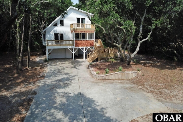 view of front of home featuring driveway, stairway, and an attached garage