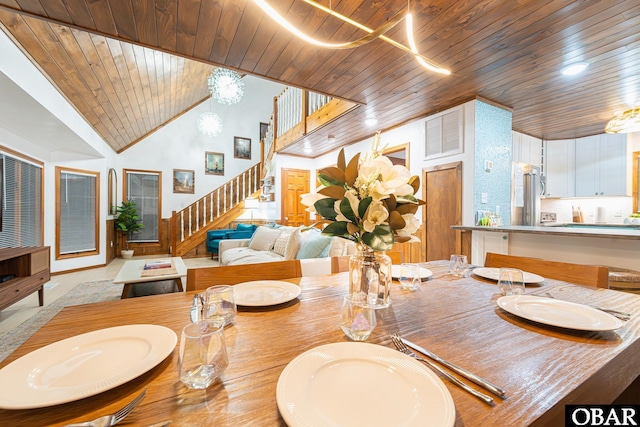 dining space featuring wooden ceiling, visible vents, stairs, and high vaulted ceiling