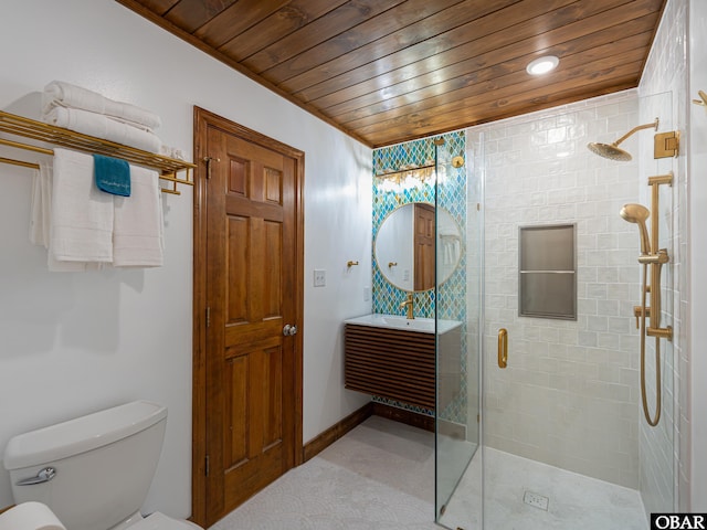 full bathroom featuring a stall shower, baseboards, toilet, wooden ceiling, and vanity