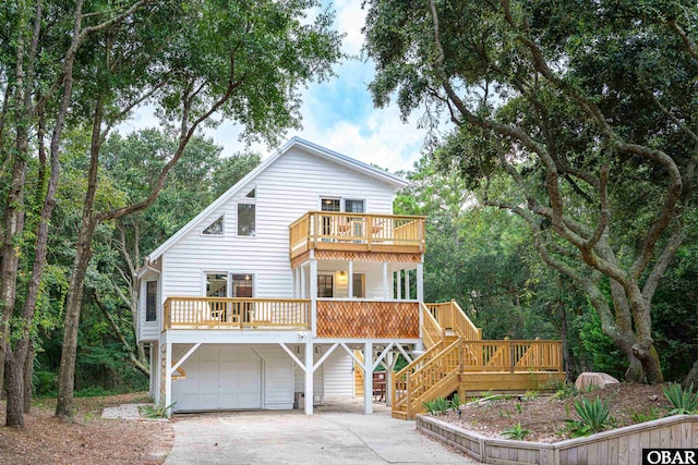 view of front of home with a garage, driveway, and stairway